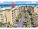 Coastal condo building with manicured landscaping, private balconies, and ample parking near the beach at 139 S Dunes Dr. # 304, Pawleys Island, SC 29585