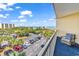 Spacious balcony with seating area overlooking ocean, parking, and lush landscape at 139 S Dunes Dr. # 304, Pawleys Island, SC 29585