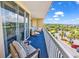 Large balcony with seating and a view of the landscape surrounding the building at 139 S Dunes Dr. # 304, Pawleys Island, SC 29585