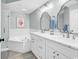 Beautifully renovated bathroom featuring double sinks, bathtub, and modern fixtures at 139 S Dunes Dr. # 304, Pawleys Island, SC 29585