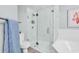Renovated bathroom showcasing a glass-enclosed shower, tub, and light blue walls at 139 S Dunes Dr. # 304, Pawleys Island, SC 29585