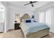 Cozy bedroom featuring large windows, ceiling fan, and beach-themed decor at 139 S Dunes Dr. # 304, Pawleys Island, SC 29585