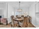Bright dining room features a round table, six chairs, and a modern chandelier at 139 S Dunes Dr. # 304, Pawleys Island, SC 29585
