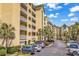 Beautiful condominium complex with multiple balconies, palm trees, and plenty of parking at 139 S Dunes Dr. # 304, Pawleys Island, SC 29585