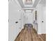Bright hallway with wood flooring, white doors, decorative lighting, and stylish decor at 139 S Dunes Dr. # 304, Pawleys Island, SC 29585