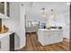 Modern kitchen featuring white cabinets, wood floors, and open layout to the living room at 139 S Dunes Dr. # 304, Pawleys Island, SC 29585