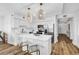 White kitchen with stainless appliances, marble countertops, wood floors, and island seating at 139 S Dunes Dr. # 304, Pawleys Island, SC 29585