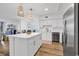 Bright, modern kitchen with white cabinets, island, and stainless steel appliances at 139 S Dunes Dr. # 304, Pawleys Island, SC 29585