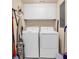 Functional laundry room with washer, dryer, and ample storage cabinets at 139 S Dunes Dr. # 304, Pawleys Island, SC 29585