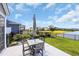 Backyard patio with an outdoor dining area and umbrella, showcasing a view of the pond and community at 1459 Villena Dr., Myrtle Beach, SC 29579