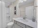 Neutral bathroom featuring a vanity with a large mirror and a tub/shower with a white shower curtain at 1459 Villena Dr., Myrtle Beach, SC 29579