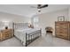 Bedroom featuring a wrought iron bed frame, ceiling fan, and wooden side tables and dresser at 1459 Villena Dr., Myrtle Beach, SC 29579