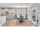 Bright dining area features wood floors, modern lighting, and a door leading to an outdoor space at 1459 Villena Dr., Myrtle Beach, SC 29579
