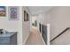 Carpeted upstairs hallway with dark metal railing and framed art hanging on the neutrally painted walls at 1459 Villena Dr., Myrtle Beach, SC 29579