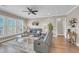Comfortable living room with plush seating, ceiling fan, and large windows with lake views at 1459 Villena Dr., Myrtle Beach, SC 29579