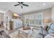 Cozy living room with lake views, television, ceiling fan, and wood floors at 1459 Villena Dr., Myrtle Beach, SC 29579