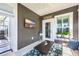 Cozy porch featuring modern decor, a mounted TV, and a welcoming atmosphere with stylish decor and plants at 1459 Villena Dr., Myrtle Beach, SC 29579