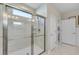 Tiled shower with glass door and skylight allows natural light into the luxurious bathroom at 1459 Villena Dr., Myrtle Beach, SC 29579