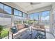 Bright sunroom with large windows, comfortable seating, and view of the backyard and adjacent body of water at 1459 Villena Dr., Myrtle Beach, SC 29579