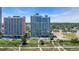 Elevated aerial view of condo buildings with pool amenities near a beach and dunes at 1700 N Ocean Blvd. # 651, Myrtle Beach, SC 29577