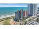 Elevated aerial shot of condo buildings near a sandy beach with ocean views and nearby parking at 1700 N Ocean Blvd. # 651, Myrtle Beach, SC 29577