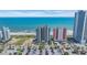 Aerial view of oceanfront condo buildings with a wide beach and blue ocean as the backdrop at 1700 N Ocean Blvd. # 651, Myrtle Beach, SC 29577