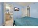 This bedroom includes a TV, tiled floors, access to the bathroom, and a comfortable blue coverlet at 1700 N Ocean Blvd. # 651, Myrtle Beach, SC 29577