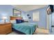 Comfortable bedroom featuring a queen-size bed with bright blue bedding and a matching nightstand at 1700 N Ocean Blvd. # 651, Myrtle Beach, SC 29577
