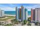 Bright, colorful condo building at the beach with ocean views and palm trees at 1700 N Ocean Blvd. # 651, Myrtle Beach, SC 29577