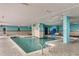 Indoor pool with waterfall feature and tile surround at 1700 N Ocean Blvd. # 651, Myrtle Beach, SC 29577