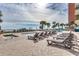Resort-style pool with lounge chairs overlooking the ocean and palm trees at 1700 N Ocean Blvd. # 651, Myrtle Beach, SC 29577