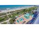 An aerial view of uniquely shaped pools with lounge chairs and palm trees near the beach at 1700 N Ocean Blvd. # 651, Myrtle Beach, SC 29577