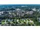 Scenic aerial view of a neighborhood with houses, ponds, landscaping, and community buildings surrounded by lush greenery at 1836 Juniper Dr., Conway, SC 29527