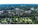 Scenic aerial view of a neighborhood with houses, ponds, landscaping, and community buildings surrounded by lush greenery at 1836 Juniper Dr., Conway, SC 29527