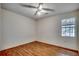 A cozy bedroom features wood floors, a ceiling fan, and a window for natural light at 1836 Juniper Dr., Conway, SC 29527