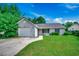 Single story home with gray siding, garage, and a green front yard at 1836 Juniper Dr., Conway, SC 29527