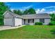 Charming single-story home with gray siding, well-maintained lawn, and attached one car garage at 1836 Juniper Dr., Conway, SC 29527