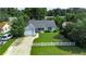 Aerial view of a single story home, with a driveway, fenced yard, and lush green trees surrounding the property at 1836 Juniper Dr., Conway, SC 29527