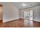 Bright, airy living room showcasing hardwood floors, high ceilings, and a sliding glass door leading to an enclosed porch at 1836 Juniper Dr., Conway, SC 29527