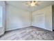 Bedroom with a ceiling fan, large window, and closet with bi-fold doors at 189 Norris Ln, Loris, SC 29569