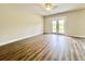 Cozy bedroom with hardwood floors, a ceiling fan, and access to the outdoor patio at 189 Norris Ln, Loris, SC 29569