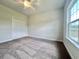 This bedroom features plush carpeting, a window for natural light, and a ceiling fan at 189 Norris Ln, Loris, SC 29569