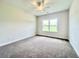A clean bedroom featuring a ceiling fan, a large window, and neutral walls at 189 Norris Ln, Loris, SC 29569
