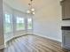 Bright dining area with hardwood floors, a modern light fixture, and views of the outdoors at 189 Norris Ln, Loris, SC 29569