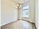 Bright dining room featuring hardwood floors, a modern chandelier, and large windows at 189 Norris Ln, Loris, SC 29569