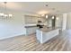 Well-equipped kitchen with gray cabinetry, granite countertops, stainless steel appliances, and island sink at 189 Norris Ln, Loris, SC 29569