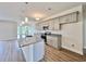 Modern kitchen showcasing a granite island, gray cabinets, stainless steel appliances, and hardwood floors at 189 Norris Ln, Loris, SC 29569