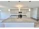 Open-concept kitchen features an island with granite countertops, gray cabinets, and stainless steel appliances at 189 Norris Ln, Loris, SC 29569