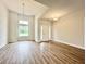 Large open living room with hardwood floors, ample natural light, and stylish ceiling fixtures at 189 Norris Ln, Loris, SC 29569