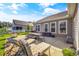 Spacious back patio featuring a dining table, grill, and lounge chairs, perfect for outdoor entertaining at 1941 La Playa Dr., Myrtle Beach, SC 29588